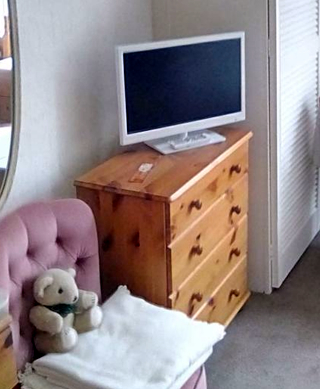 Bedroom with TV and comfy chair